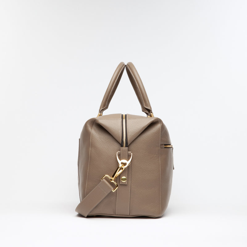 Taupe Weekend Travel Bag made of Italian leather with gold hardware. Dimension: 18.5" L x 11.5" H x 8.5" D. Made in Spain