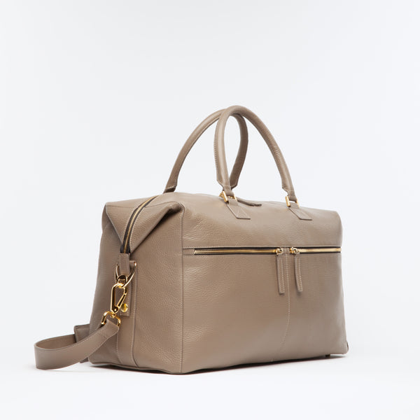 Taupe Weekend Travel Bag made of Italian leather with gold hardware. Dimension: 18.5" L x 11.5" H x 8.5" D. Made in Spain